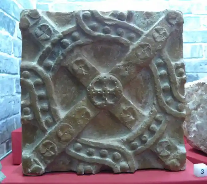 A cross on a stone with solar disc